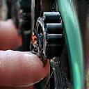 A cyclist adjusting a new, high-tech gear system on a touring bike, looking thoughtful.